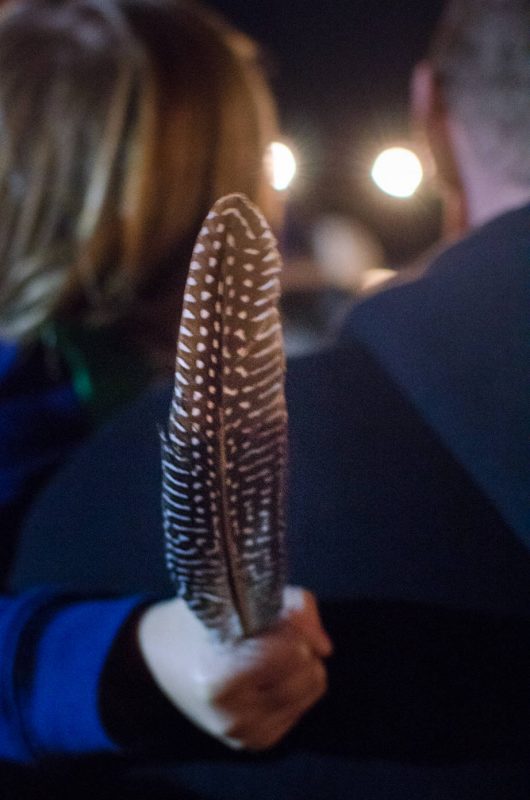 A child grasping a feather - Huon Valley Mid Winter Festival