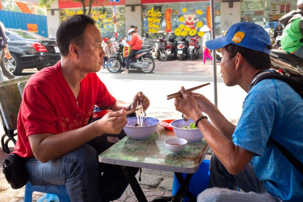 People eating street food in Saigon